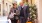 man and woman carry shopping bags while walking outdoors